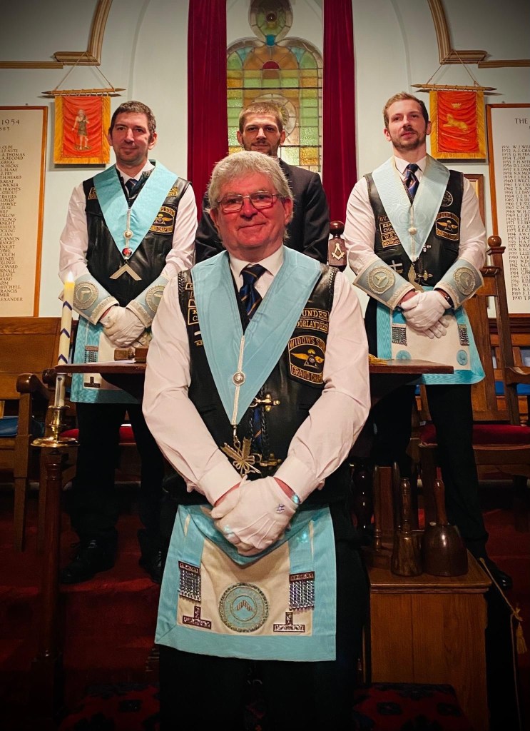 Father raising son, with his two elder sons in the Wardens’ chairs at the Earl of St Germans No 7031